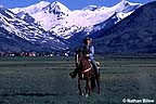 Horseback rider with town in background