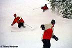 Snowboarders enjoying fresh snowfall